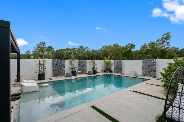 view of swimming pool featuring a patio area, a fenced backyard, and a fenced in pool