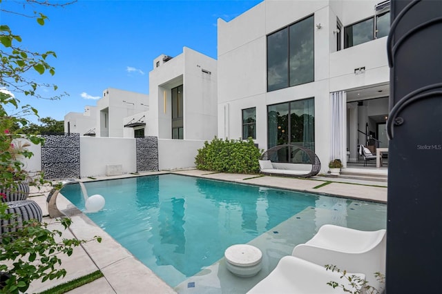 view of pool with a fenced in pool, a patio area, and fence