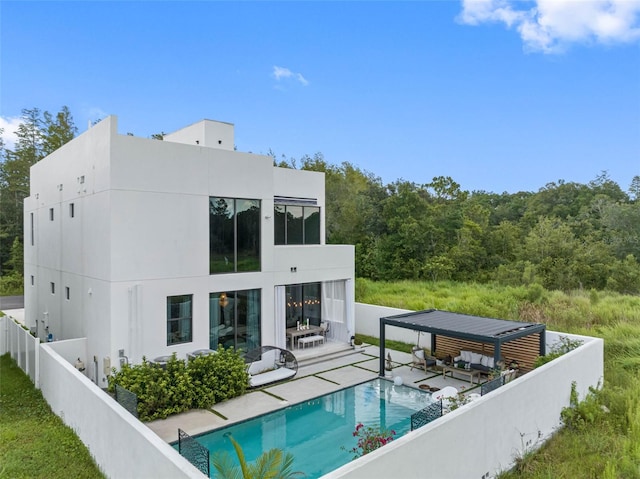 back of property with a patio area, a fenced in pool, an outdoor hangout area, and a fenced backyard