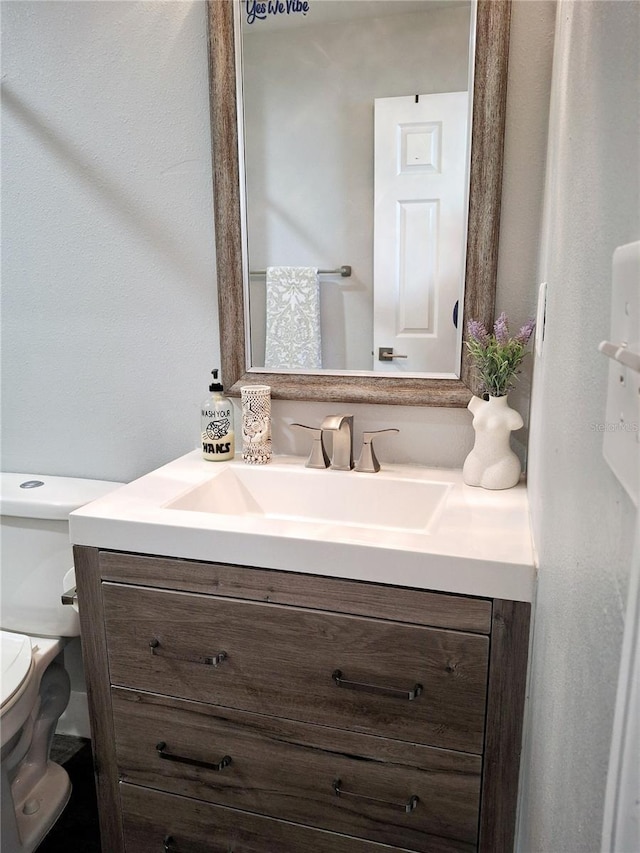 bathroom with toilet and vanity