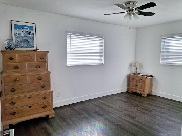 bedroom featuring dark wood-type flooring, ceiling fan, and multiple windows