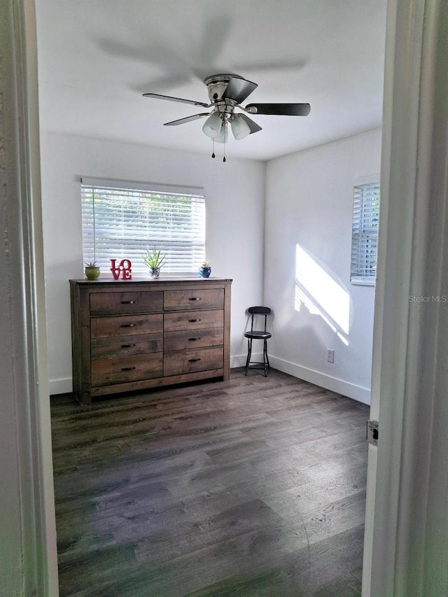 bedroom with ceiling fan and dark wood-type flooring