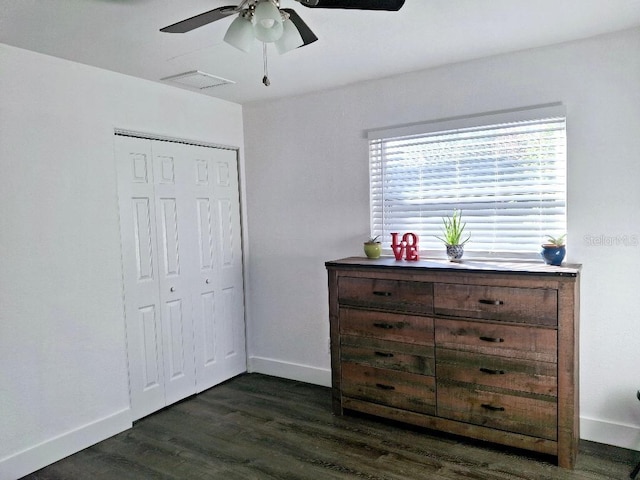 bedroom with ceiling fan, dark hardwood / wood-style flooring, and a closet