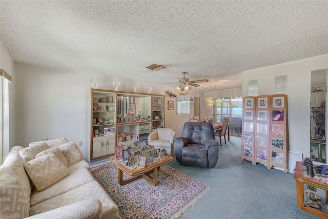 living room featuring carpet flooring, ceiling fan, and a textured ceiling