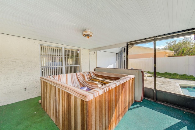 sunroom featuring a hot tub