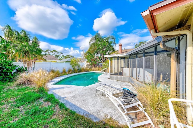 view of pool featuring a patio area and a sunroom