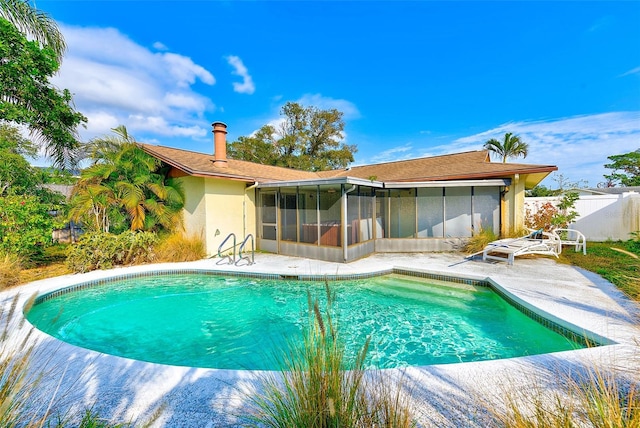 view of pool featuring a patio area and a sunroom