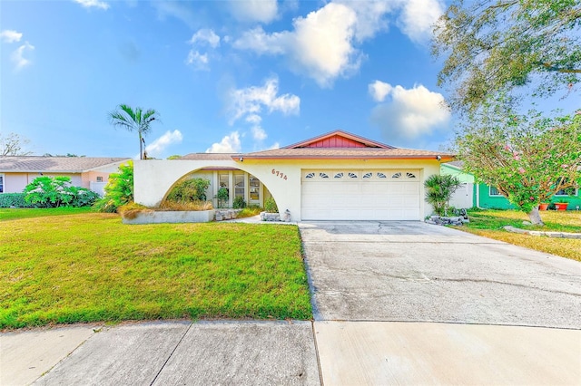 ranch-style home with a garage and a front yard