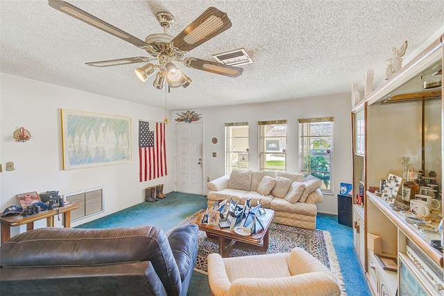 carpeted living room with a textured ceiling and ceiling fan