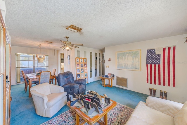 carpeted living room with ceiling fan and a textured ceiling