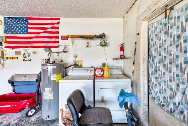 laundry area featuring washing machine and clothes dryer, a textured ceiling, and water heater