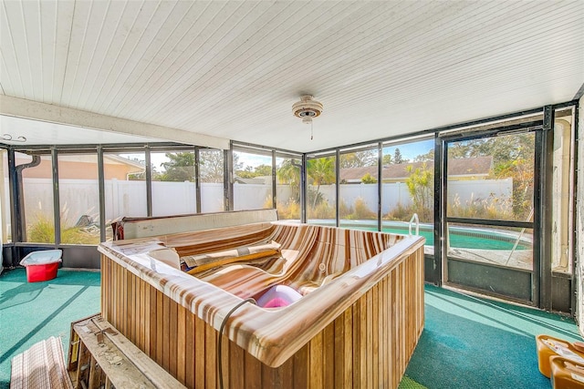 sunroom featuring a hot tub