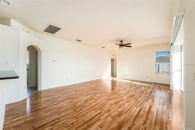 unfurnished living room featuring ceiling fan and light wood-type flooring