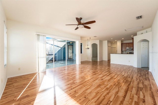 unfurnished living room featuring ceiling fan and light wood-type flooring