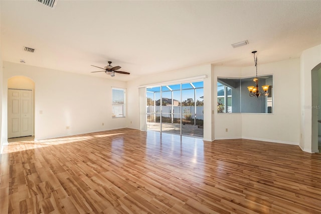 interior space featuring hardwood / wood-style floors and ceiling fan with notable chandelier