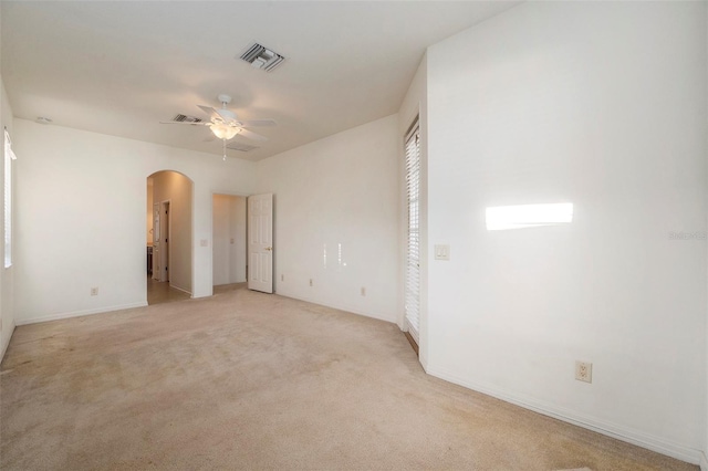 unfurnished bedroom featuring light carpet and ceiling fan