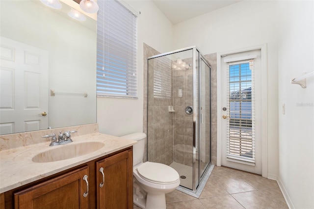 bathroom with toilet, vanity, tile patterned floors, and walk in shower