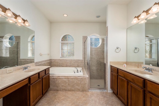 bathroom featuring tile patterned flooring, vanity, and shower with separate bathtub