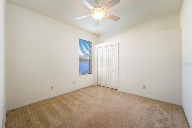 carpeted spare room with ceiling fan