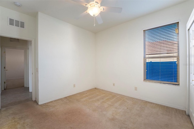 empty room with light carpet and ceiling fan