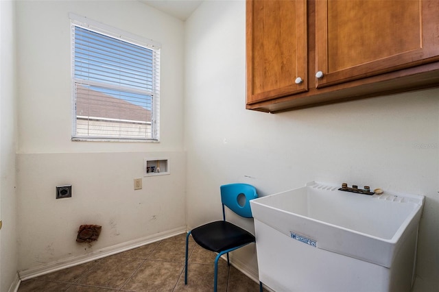 clothes washing area featuring cabinets, hookup for a washing machine, hookup for an electric dryer, sink, and tile patterned flooring