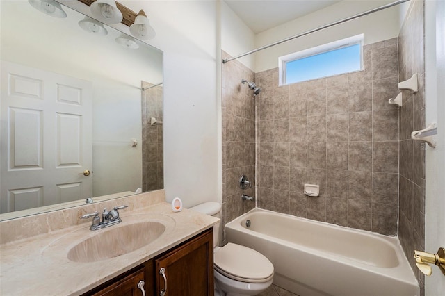 full bathroom featuring toilet, vanity, and tiled shower / bath