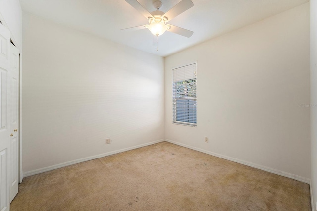 empty room featuring light carpet and ceiling fan