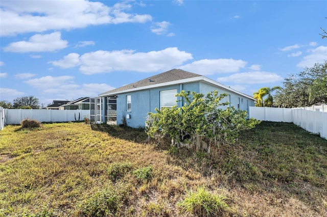 rear view of property with a lawn