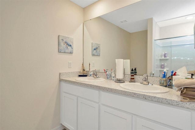 bathroom featuring vanity and a shower with door