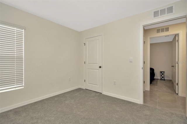 unfurnished bedroom with light colored carpet