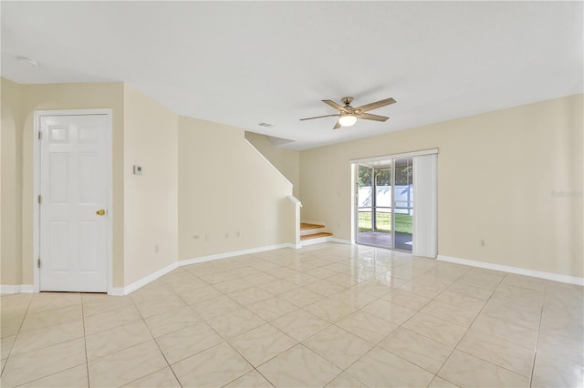 empty room with light tile patterned floors and ceiling fan