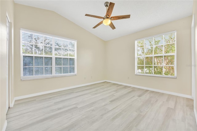 unfurnished room with ceiling fan, light hardwood / wood-style floors, plenty of natural light, and lofted ceiling