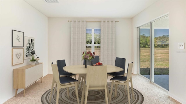 dining space with light carpet and a healthy amount of sunlight