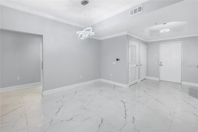 unfurnished room with a raised ceiling, crown molding, and an inviting chandelier