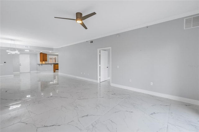 empty room featuring ceiling fan and crown molding