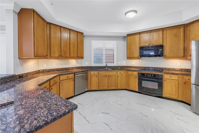 kitchen featuring black appliances, a raised ceiling, sink, and dark stone counters