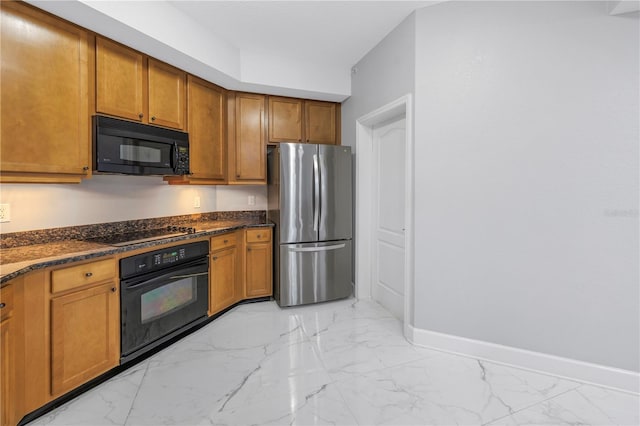 kitchen featuring dark stone countertops and black appliances