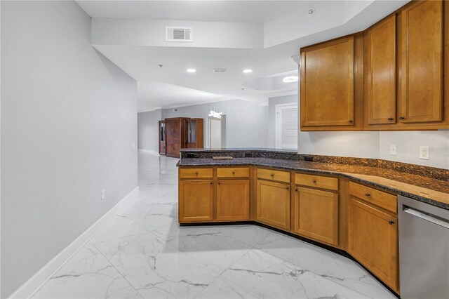 kitchen with kitchen peninsula, dark stone countertops, and dishwasher