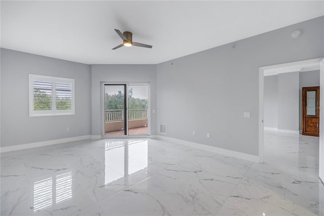 empty room with a wealth of natural light and ceiling fan