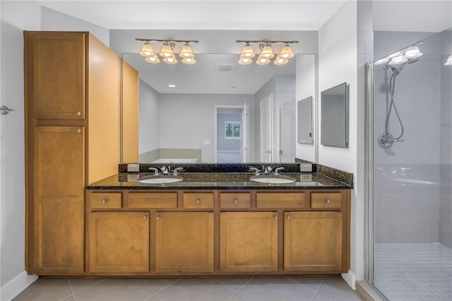 bathroom featuring tile patterned flooring, vanity, and a shower with shower door