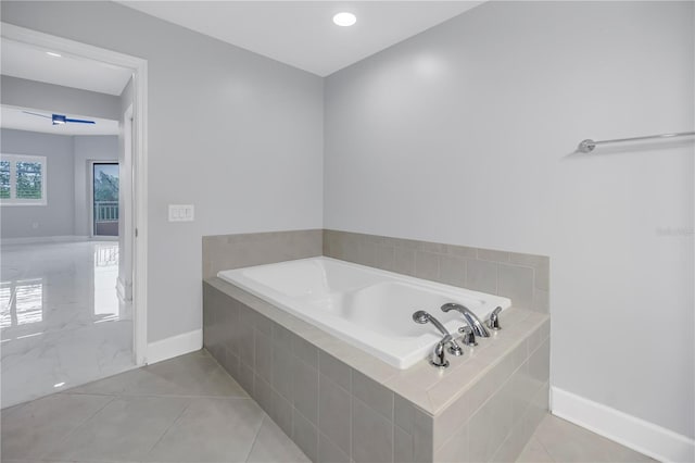 bathroom with tile patterned flooring and a relaxing tiled tub