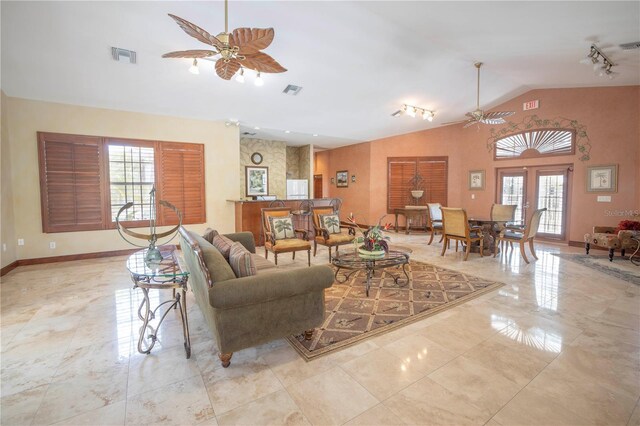 living room featuring plenty of natural light, lofted ceiling, and ceiling fan