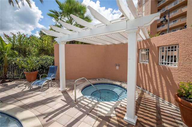 view of swimming pool with a community hot tub, a pergola, and a patio