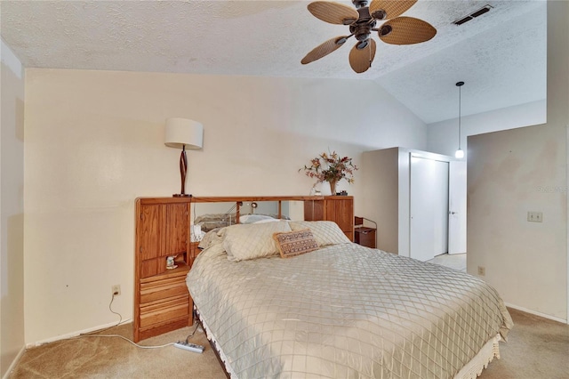 bedroom with lofted ceiling, ceiling fan, light colored carpet, and a textured ceiling