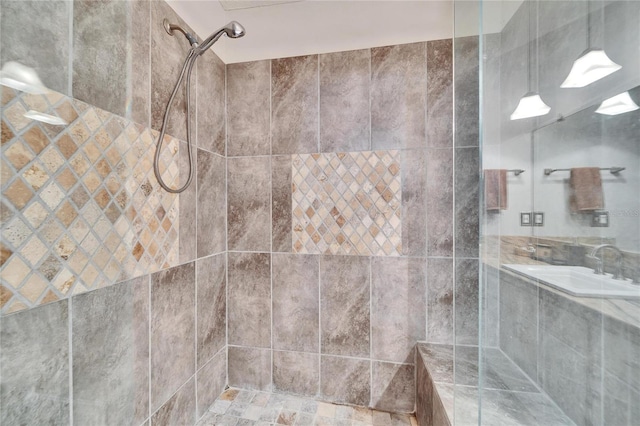 interior details with sink and a tile shower