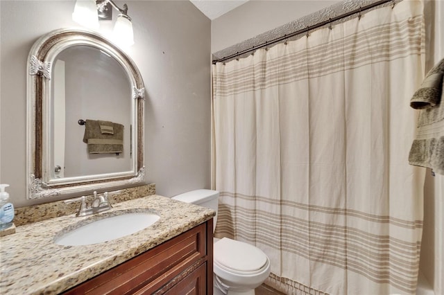 bathroom with vanity, toilet, and walk in shower