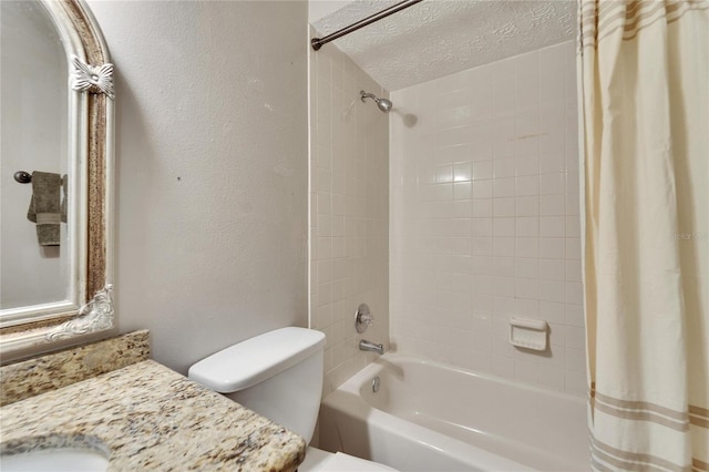 full bathroom with vanity, toilet, shower / tub combo, and a textured ceiling