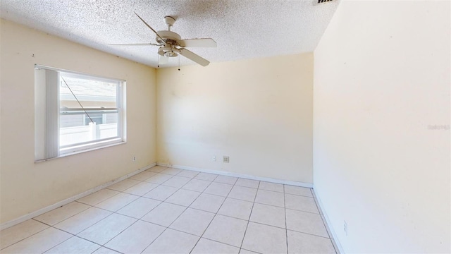 tiled spare room featuring ceiling fan and a textured ceiling