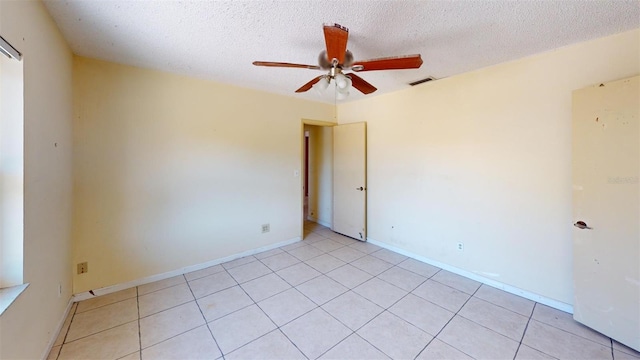 unfurnished room with light tile patterned floors, a textured ceiling, and ceiling fan