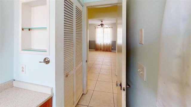 hall featuring light tile patterned flooring